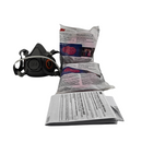 Black respirator mask with filter cartridges on a white background